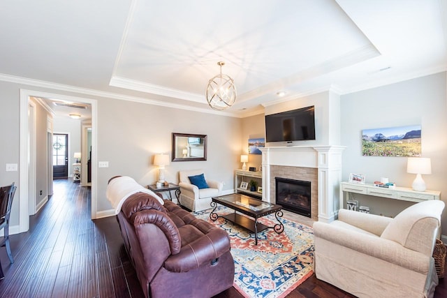 7040 Wenlock Ln, Franklin, TN 37064 - living room featuring a tray ceiling, wood-type flooring, a fireplace, a chandelier, and ornamental molding