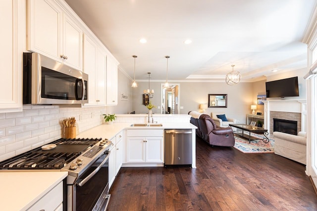 7040 Wenlock Ln, Franklin, TN 37064 - kitchen with appliances with stainless steel finishes, a chandelier, dark wood-type flooring, open floor plan, and recessed lighting