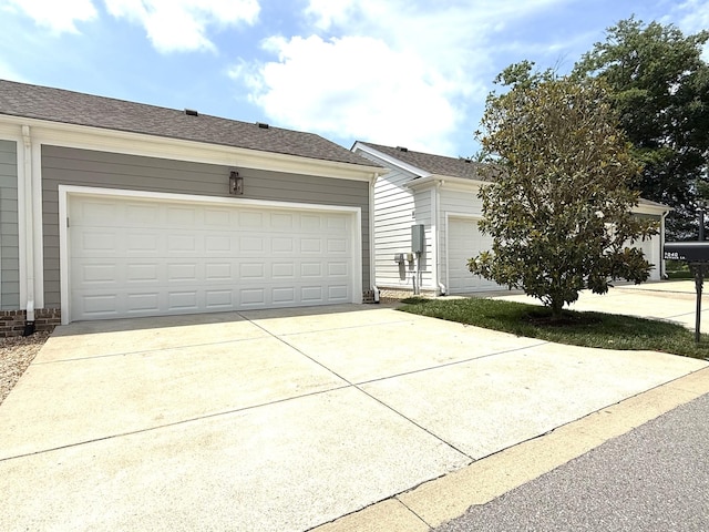 7040 Wenlock Ln, Franklin, TN 37064 - view of front of home featuring a garage, a shingled roof, and driveway
