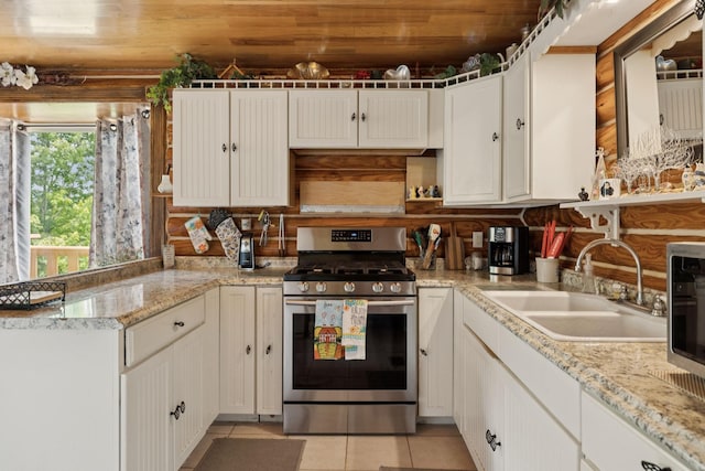 32 Morris Ln, Pleasant Shade, TN 37145 - kitchen featuring stainless steel range with gas stovetop, light tile patterned floors, white cabinets, backsplash, and wooden ceiling