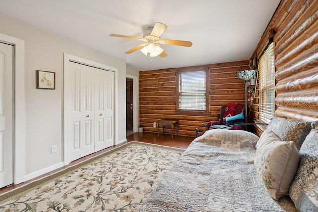 32 Morris Ln, Pleasant Shade, TN 37145 - bedroom featuring log walls, ceiling fan, wood finished floors, and a closet