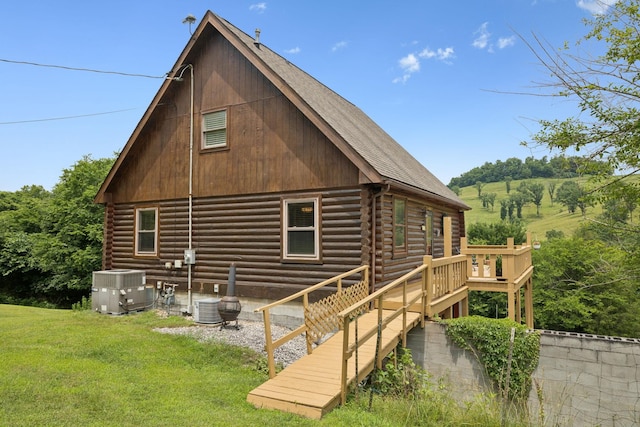 32 Morris Ln, Pleasant Shade, TN 37145 - back of house with log siding, a lawn, a wooden deck, and a shingled roof