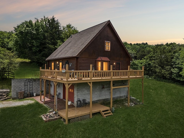 32 Morris Ln, Pleasant Shade, TN 37145 - rear view of house with a wooden deck, log siding, and a lawn