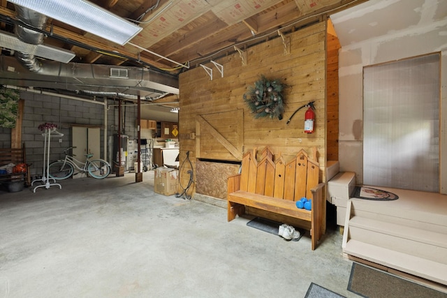 32 Morris Ln, Pleasant Shade, TN 37145 - unfinished below grade area featuring water heater and wood walls