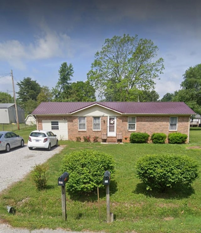 175 Willow Run, Mcminnville, TN 37110 - ranch-style house featuring a metal roof, a front yard, brick siding, gravel driveway, and entry steps