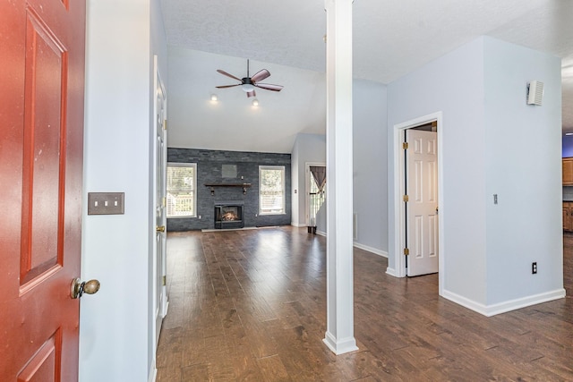 1622 Hickory Valley Rd, Lebanon, TN 37087 - unfurnished living room featuring vaulted ceiling, dark wood-type flooring, a ceiling fan, and a stone fireplace