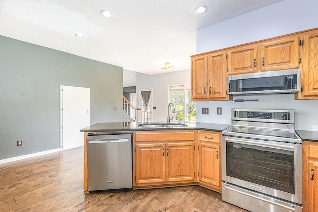 1622 Hickory Valley Rd, Lebanon, TN 37087 - kitchen featuring appliances with stainless steel finishes, a peninsula, light wood-style flooring, and recessed lighting