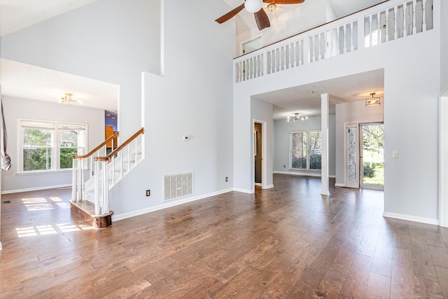 1622 Hickory Valley Rd, Lebanon, TN 37087 - unfurnished living room with a high ceiling, wood finished floors, stairs, a ceiling fan, and a chandelier