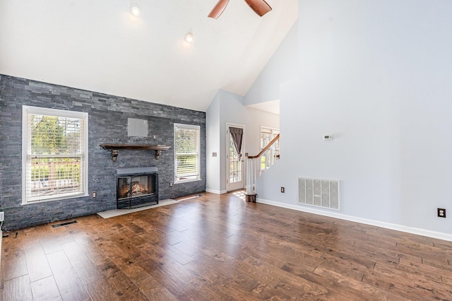 1622 Hickory Valley Rd, Lebanon, TN 37087 - unfurnished living room featuring high vaulted ceiling, stairway, wood finished floors, a fireplace, and a ceiling fan
