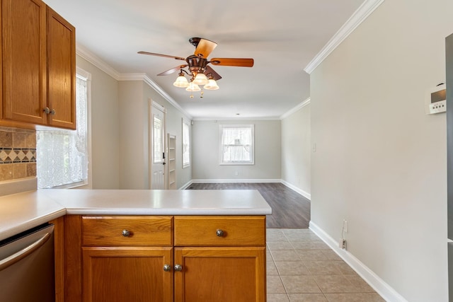1519 Preston Dr, Nashville, TN 37206 - kitchen with dishwasher, a peninsula, ceiling fan, light countertops, and ornamental molding