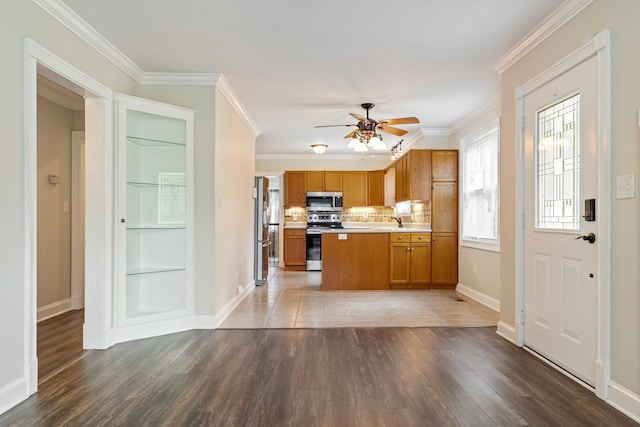 1519 Preston Dr, Nashville, TN 37206 - kitchen with stainless steel appliances, light countertops, a ceiling fan, brown cabinets, and wood finished floors