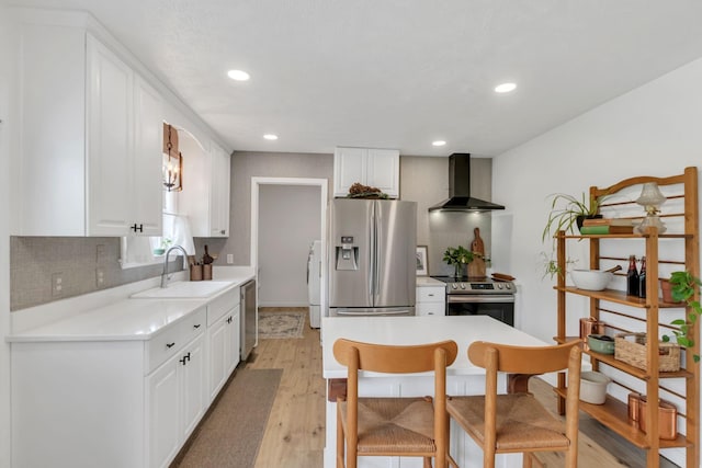 1511 Bridle Ln, Chapel Hill, TN 37034 - kitchen featuring wall chimney range hood, appliances with stainless steel finishes, light wood-style flooring, decorative backsplash, and light countertops