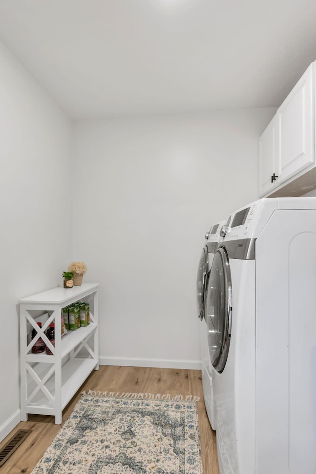 1511 Bridle Ln, Chapel Hill, TN 37034 - washroom with separate washer and dryer, cabinet space, and light wood-style flooring