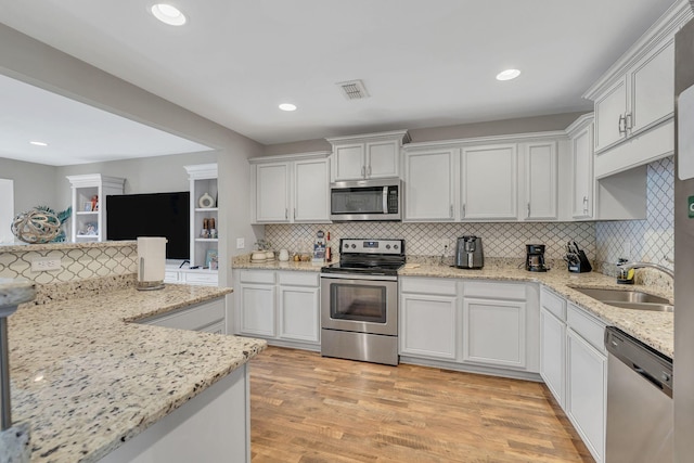 4418 Prometheus Way, Murfreesboro, TN 37128 - kitchen featuring appliances with stainless steel finishes, tasteful backsplash, white cabinetry, light wood-style floors, and recessed lighting