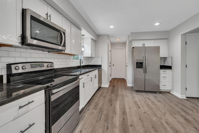 545 Old Lebanon Dirt Rd, Hermitage, TN 37076 - kitchen with stainless steel appliances, light wood finished floors, white cabinetry, and recessed lighting
