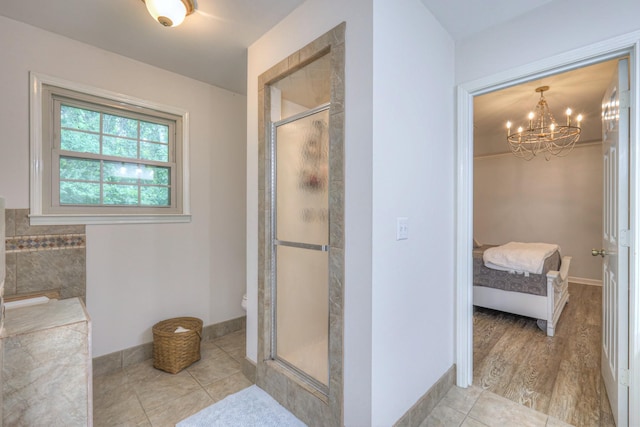 943 E Northfield Blvd, Murfreesboro, TN 37130 - ensuite bathroom featuring a shower stall, a chandelier, and tile patterned floors