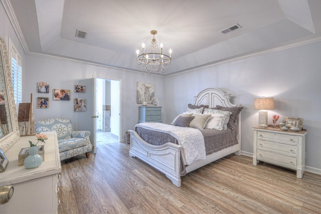 943 E Northfield Blvd, Murfreesboro, TN 37130 - bedroom with a tray ceiling, light wood finished floors, a chandelier, and ornamental molding