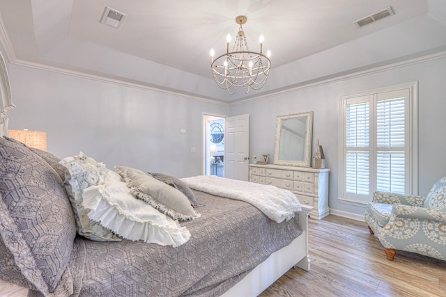 943 E Northfield Blvd, Murfreesboro, TN 37130 - bedroom featuring a tray ceiling, a chandelier, light wood-style flooring, and ornamental molding