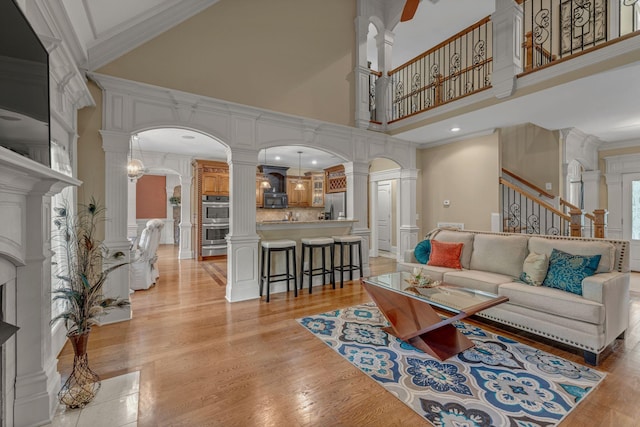 2711 Crowne Pointe Dr, Murfreesboro, TN 37130 - living area featuring a high ceiling, a decorative wall, decorative columns, stairway, and ornamental molding