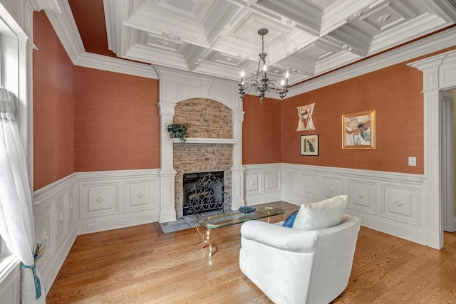 2711 Crowne Pointe Dr, Murfreesboro, TN 37130 - living room featuring coffered ceiling, a chandelier, a fireplace, crown molding, and light wood-style floors