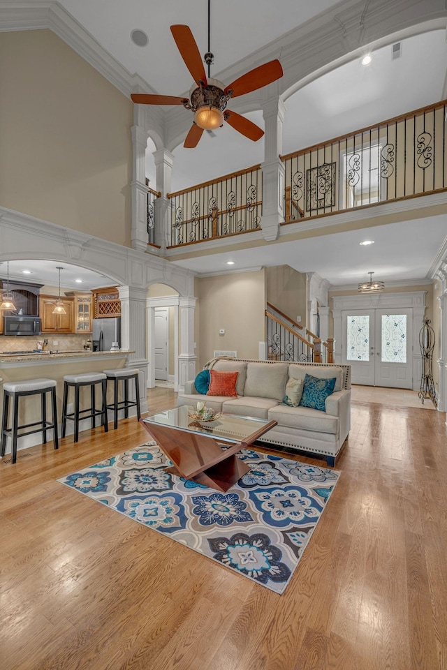2711 Crowne Pointe Dr, Murfreesboro, TN 37130 - living room with decorative columns, a high ceiling, arched walkways, a ceiling fan, and french doors