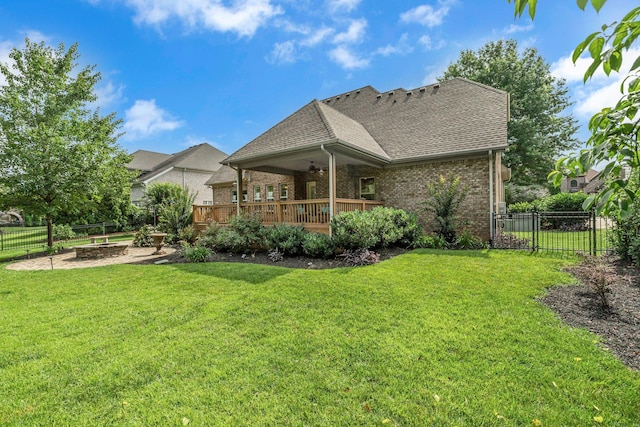 2711 Crowne Pointe Dr, Murfreesboro, TN 37130 - back of property with an outdoor fire pit, a fenced backyard, brick siding, and a shingled roof