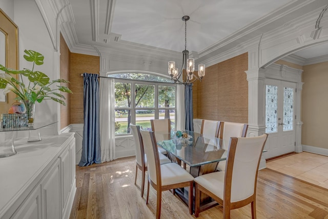 2711 Crowne Pointe Dr, Murfreesboro, TN 37130 - dining room featuring a chandelier, light wood-style floors, ornamental molding, ornate columns, and arched walkways