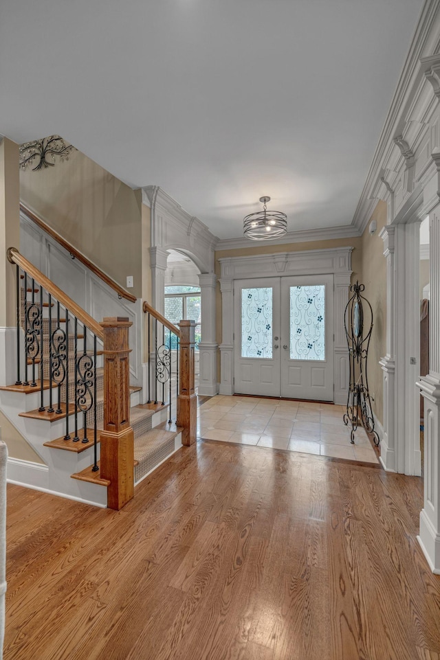 2711 Crowne Pointe Dr, Murfreesboro, TN 37130 - foyer featuring decorative columns, a decorative wall, wood finished floors, crown molding, and stairway