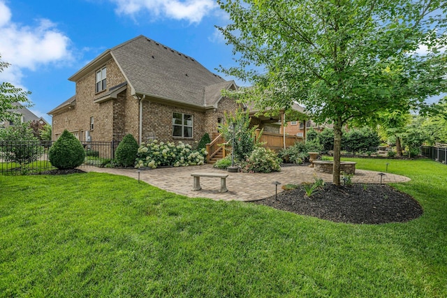 2711 Crowne Pointe Dr, Murfreesboro, TN 37130 - back of house with brick siding, a patio area, roof with shingles, a fenced backyard, and a wooden deck