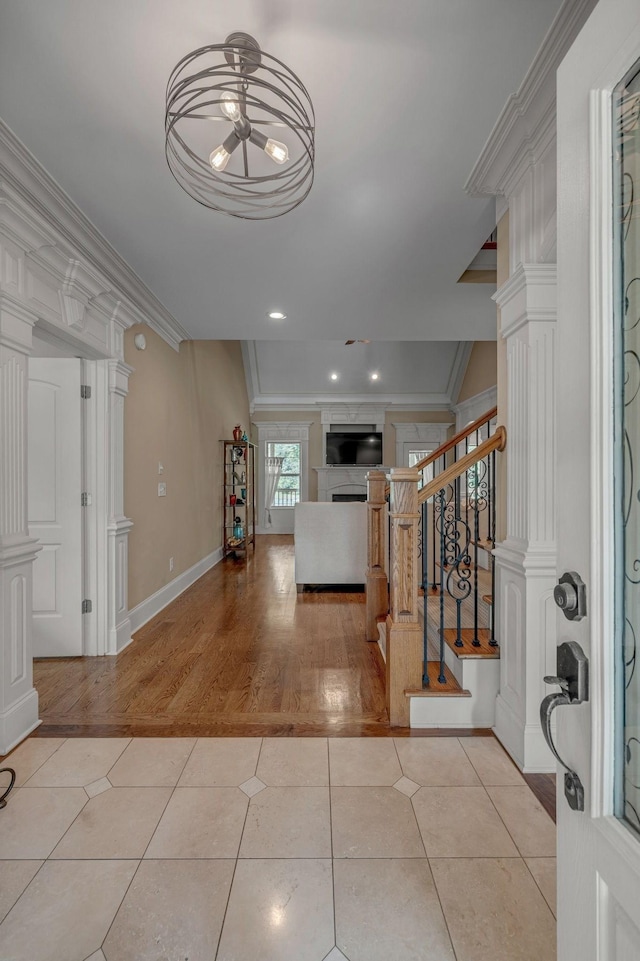 2711 Crowne Pointe Dr, Murfreesboro, TN 37130 - foyer featuring a fireplace, ornamental molding, stairs, a ceiling fan, and wood finished floors
