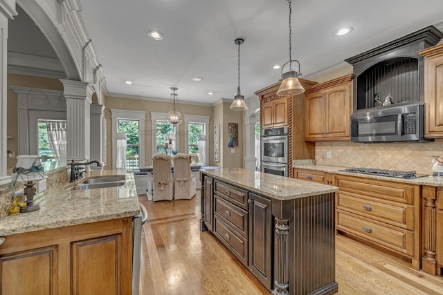 2711 Crowne Pointe Dr, Murfreesboro, TN 37130 - kitchen featuring stainless steel appliances, a kitchen island, crown molding, decorative columns, and recessed lighting