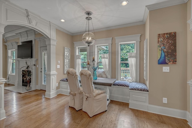 2711 Crowne Pointe Dr, Murfreesboro, TN 37130 - dining space with decorative columns, light wood-type flooring, arched walkways, recessed lighting, and a fireplace