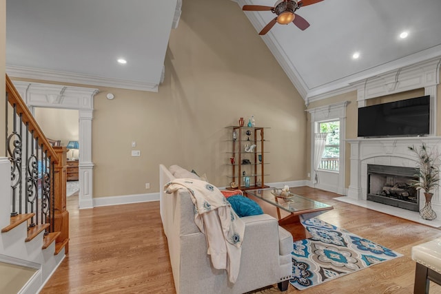 2711 Crowne Pointe Dr, Murfreesboro, TN 37130 - living room featuring crown molding, stairway, a ceiling fan, light wood-style flooring, and a tiled fireplace