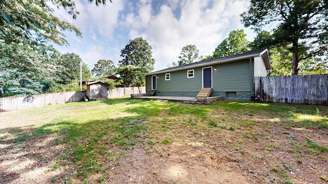 152 Mink Branch Rd E, Waynesboro, TN 38485 - rear view of house with entry steps, a fenced backyard, and a storage unit