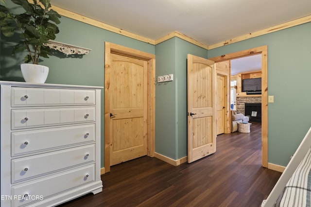 645 Bankston Ln, La Follette, TN 37766 - bedroom with dark wood-style flooring and a stone fireplace