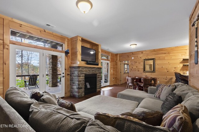 645 Bankston Ln, La Follette, TN 37766 - living room featuring wooden walls, dark wood finished floors, plenty of natural light, and a fireplace