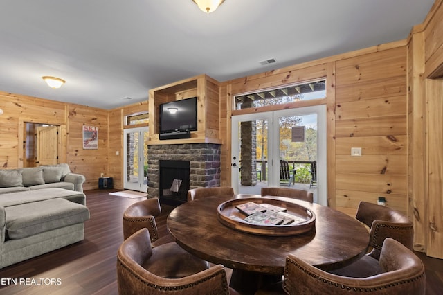 645 Bankston Ln, La Follette, TN 37766 - dining area with wooden walls, a stone fireplace, dark wood finished floors, and french doors