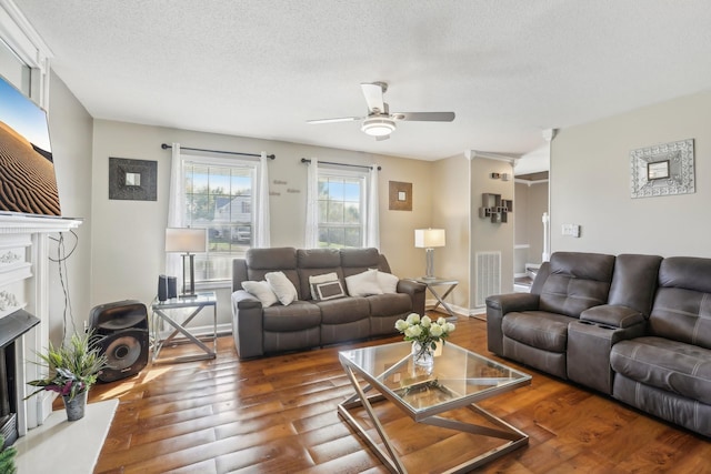 1287 Cheryl Ct, Clarksville, TN 37042 - living area featuring a fireplace, ceiling fan, wood finished floors, and a textured ceiling