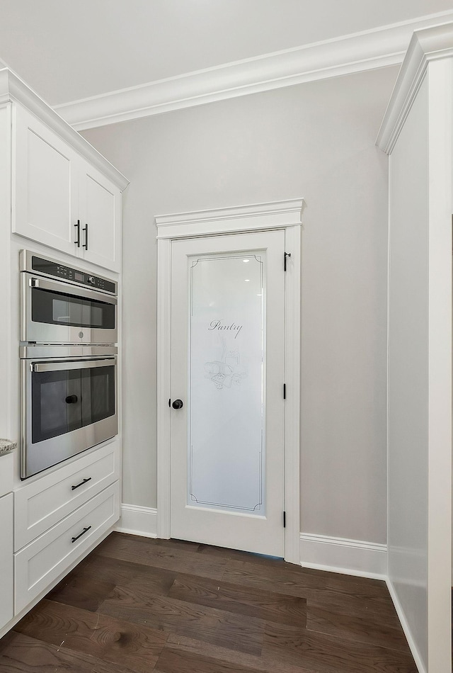 991 Scenic Dr, Pulaski, TN 38478 - kitchen featuring stainless steel double oven, crown molding, dark wood-type flooring, and white cabinetry