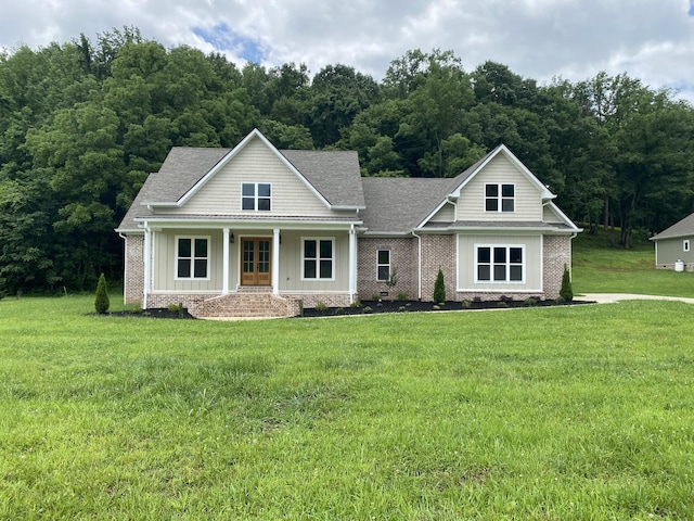 991 Scenic Dr, Pulaski, TN 38478 - view of front of house featuring a front yard, board and batten siding, covered porch, and brick siding