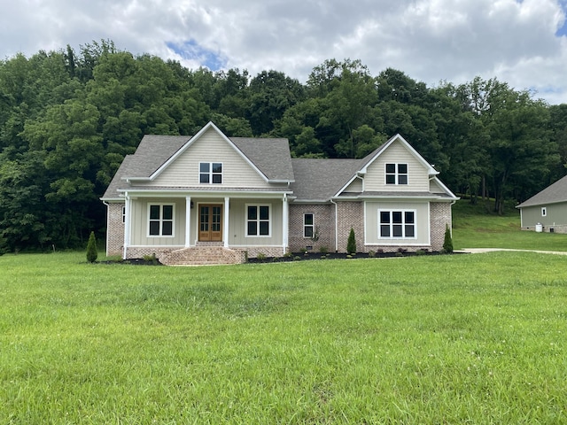 991 Scenic Dr, Pulaski, TN 38478 - view of front of home with a front lawn, board and batten siding, brick siding, and a porch
