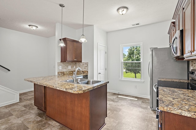 164 Ramsden Ave, La Vergne, TN 37086 - kitchen with stainless steel appliances, backsplash, a peninsula, hanging light fixtures, and a textured ceiling