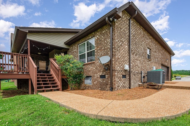 212 Hickory Pointe Dr, Lebanon, TN 37087 - view of property exterior with a garage, stairway, a deck, and brick siding