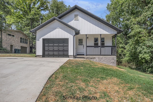 685 Red Bud Ln, Pulaski, TN 38478 - view of front of home with an attached garage, covered porch, driveway, and a front lawn