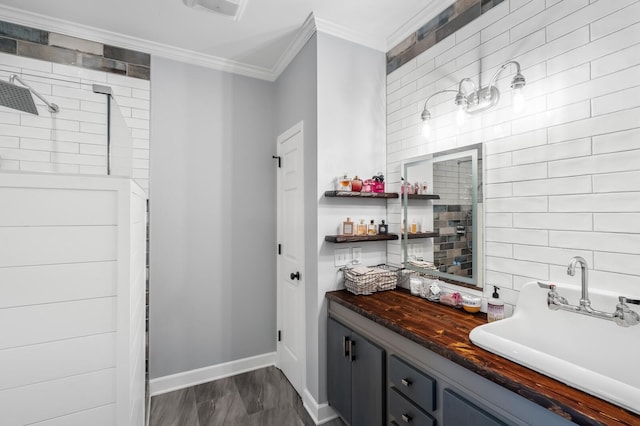 7871 Oscar Green Rd, Primm Springs, TN 38476 - bathroom with crown molding, a tile shower, tasteful backsplash, vanity, and wood finished floors