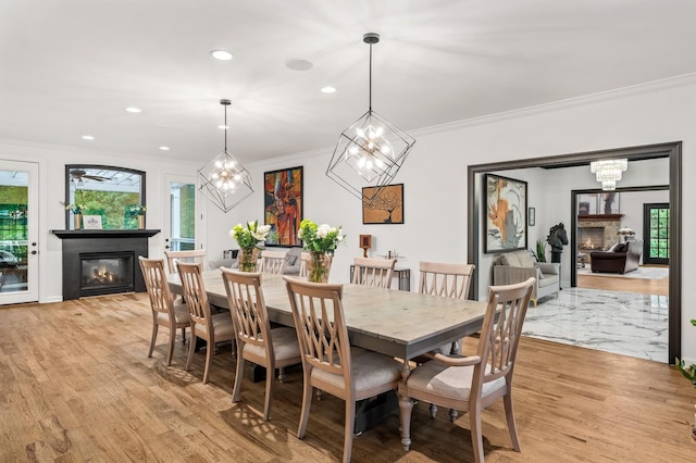7871 Oscar Green Rd, Primm Springs, TN 38476 - dining space featuring a glass covered fireplace, ornamental molding, light wood-style floors, a chandelier, and recessed lighting