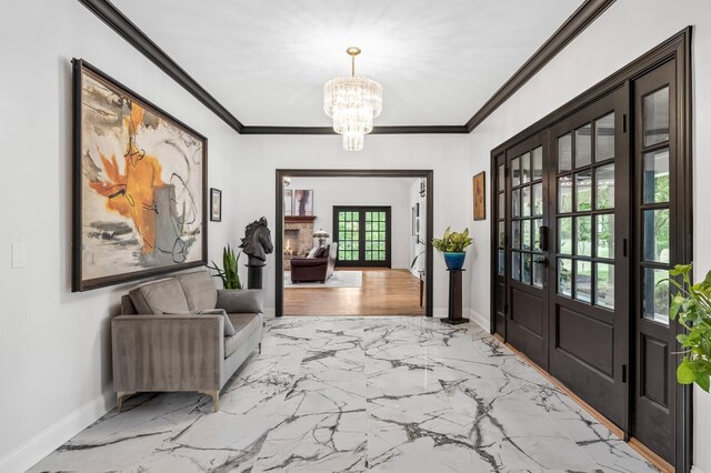 7871 Oscar Green Rd, Primm Springs, TN 38476 - entryway with french doors, a chandelier, ornamental molding, and light marble finish flooring