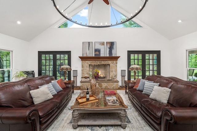 7871 Oscar Green Rd, Primm Springs, TN 38476 - living area featuring high vaulted ceiling, french doors, a chandelier, a stone fireplace, and recessed lighting