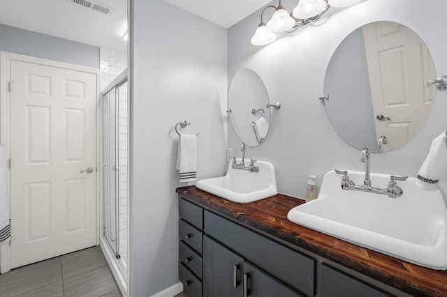7871 Oscar Green Rd, Primm Springs, TN 38476 - full bathroom featuring a shower stall, double vanity, and tile patterned floors