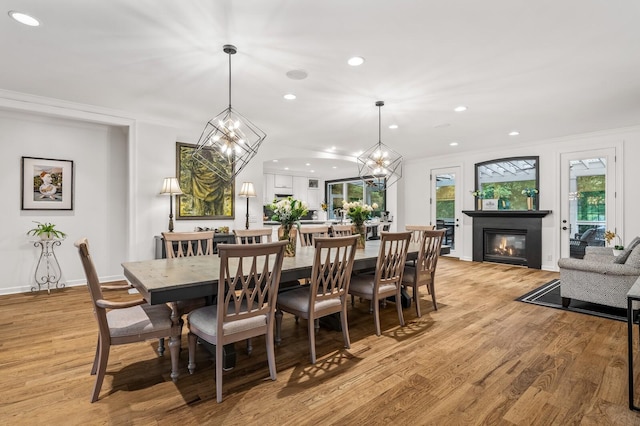 7871 Oscar Green Rd, Primm Springs, TN 38476 - dining room featuring a glass covered fireplace, light wood-style flooring, recessed lighting, and ornamental molding